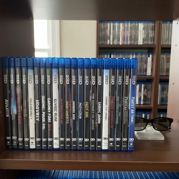 A collection of 3D Blu-ray movie cases on a shelf, hinting at physical media for 3D content in 2026.