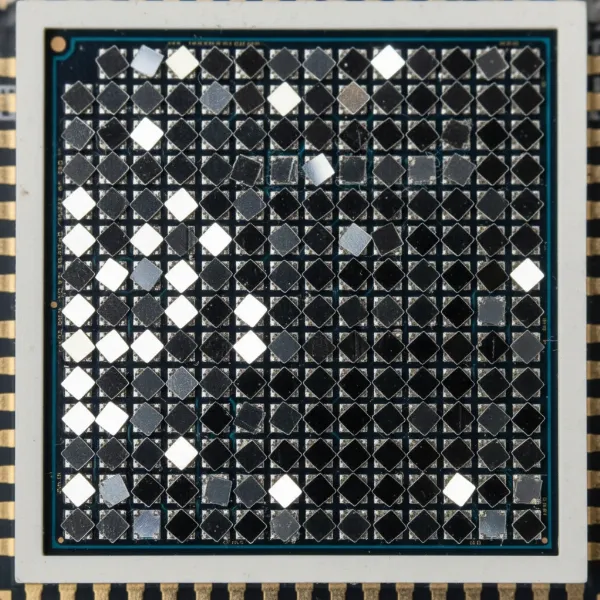 A close-up image of a DLP DMD chip showing millions of tiny, reflective micromirrors.